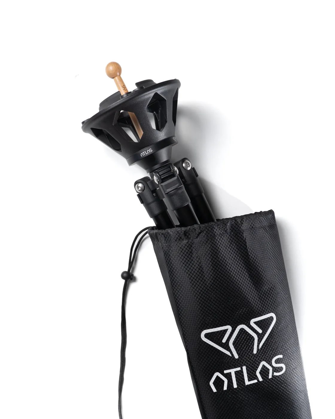 The folded Atlas Pro next to its Atlas Bag carrying case, in black fabric marked with the Atlas logo.