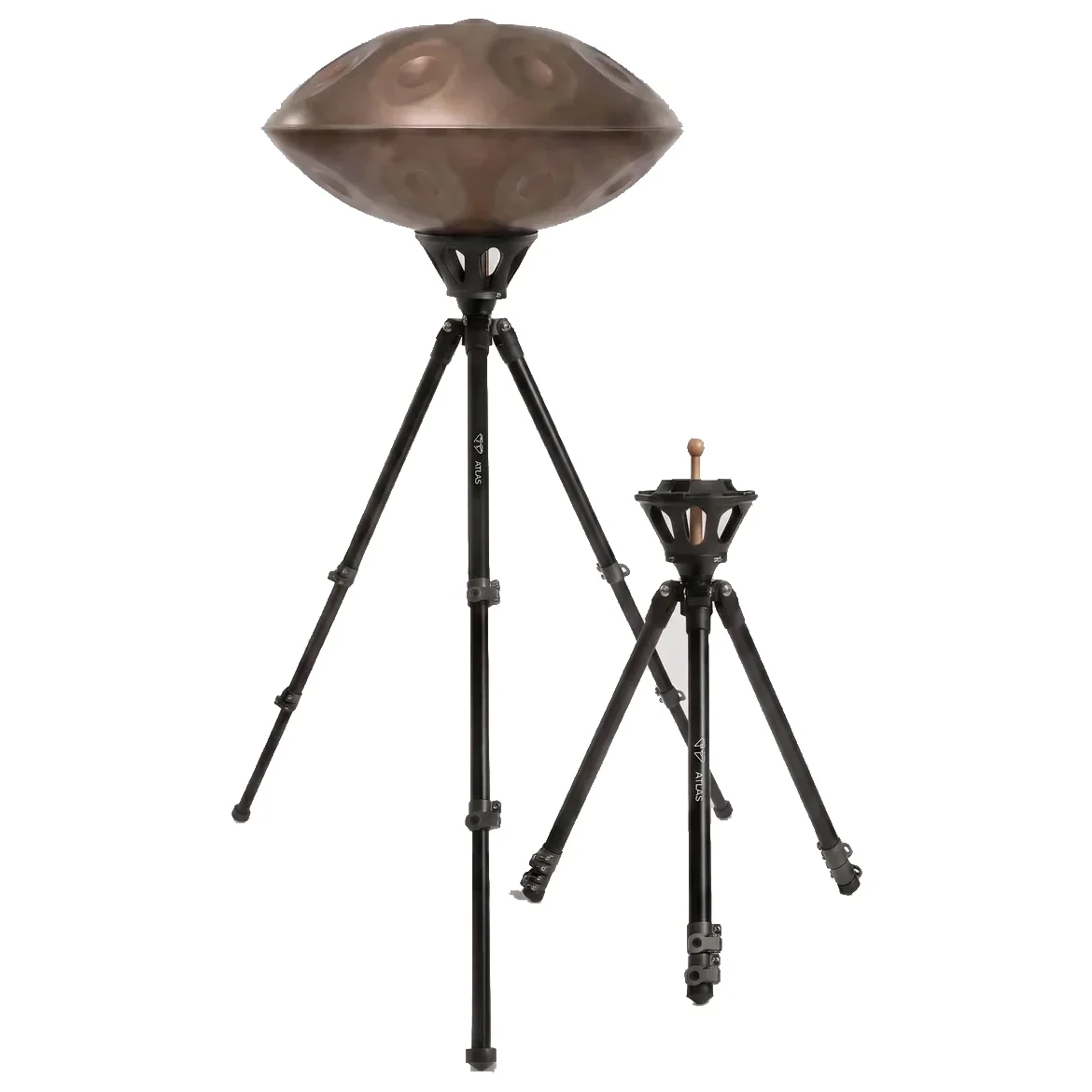 Two Atlas Pro tripods side by side on a grey background: the left one extended to its high position carrying a steel handpan, the right one set low with its legs drawn in.